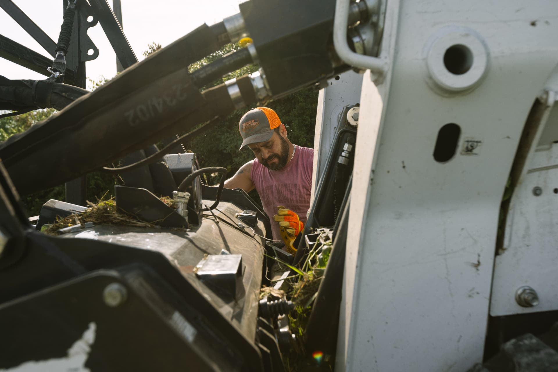 Operator inspecting forestry mulching equipment on the job site